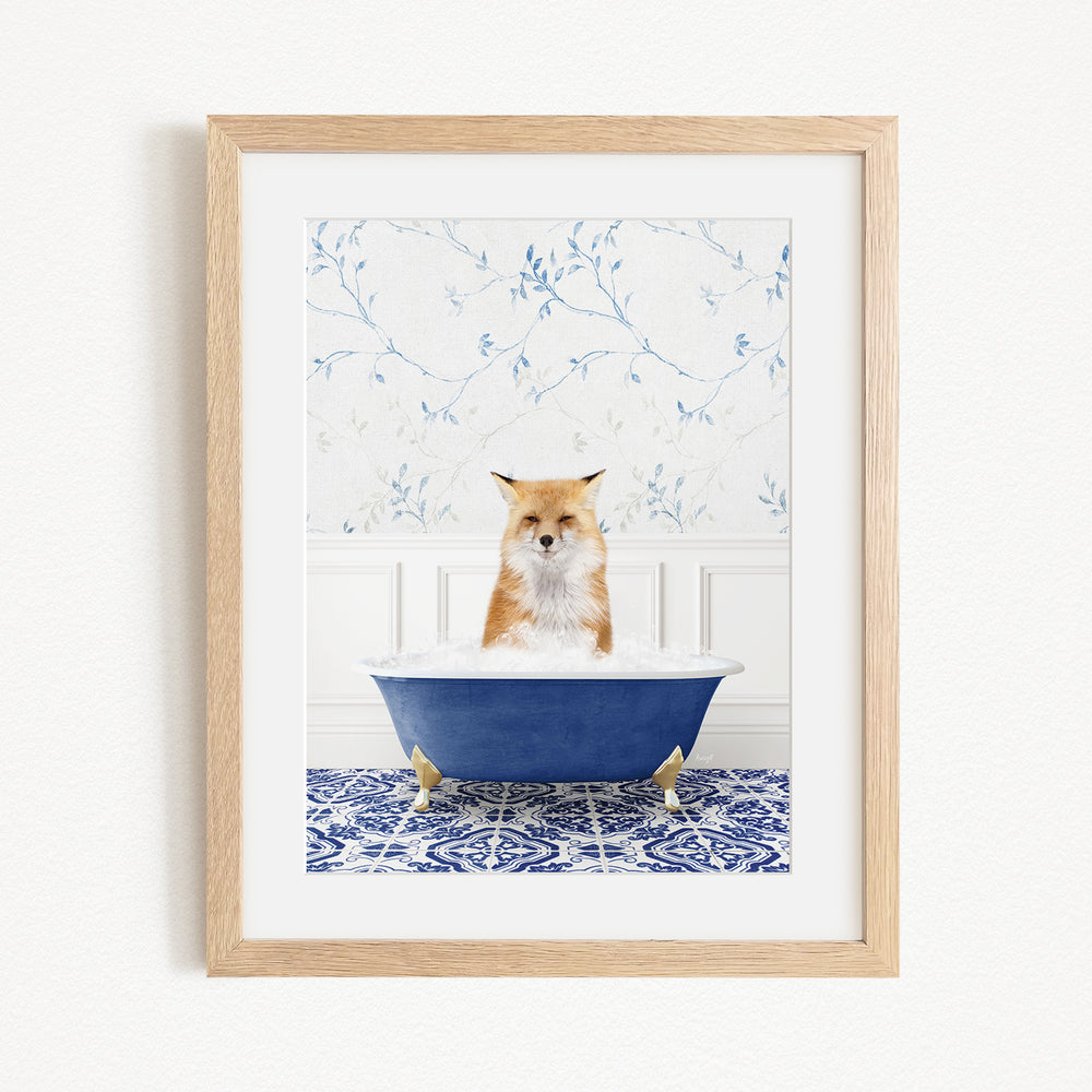 A red fox is sitting in a blue bathtub, with a white and blue floral patterned wall behind it.
