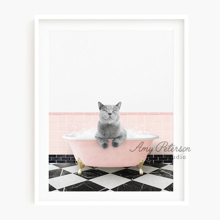 a gray cat sitting in a pink bath tub