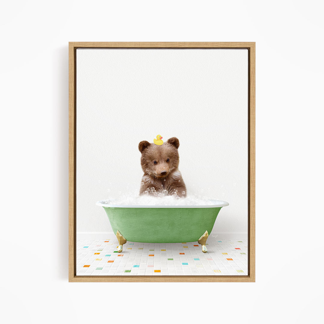 A cute brown bear sitting in a green bathtub filled with bubbles, with a yellow rubber duck perched on its head.