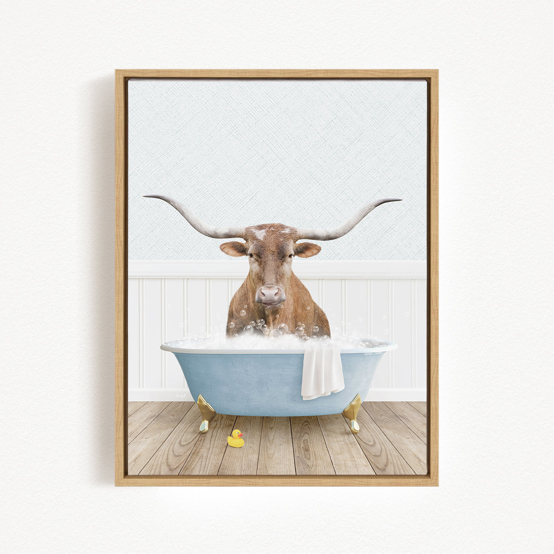 A brown cow with long horns is sitting in a blue bathtub filled with water, surrounded by a white wall and wooden floor.