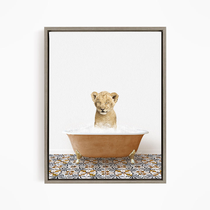 A young lion cub sitting in a bathtub filled with water, surrounded by a patterned tile floor.