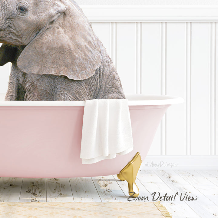 A large gray elephant is sitting in a pink bathtub, with a white towel hanging on the side and a gold bathtub faucet visible.