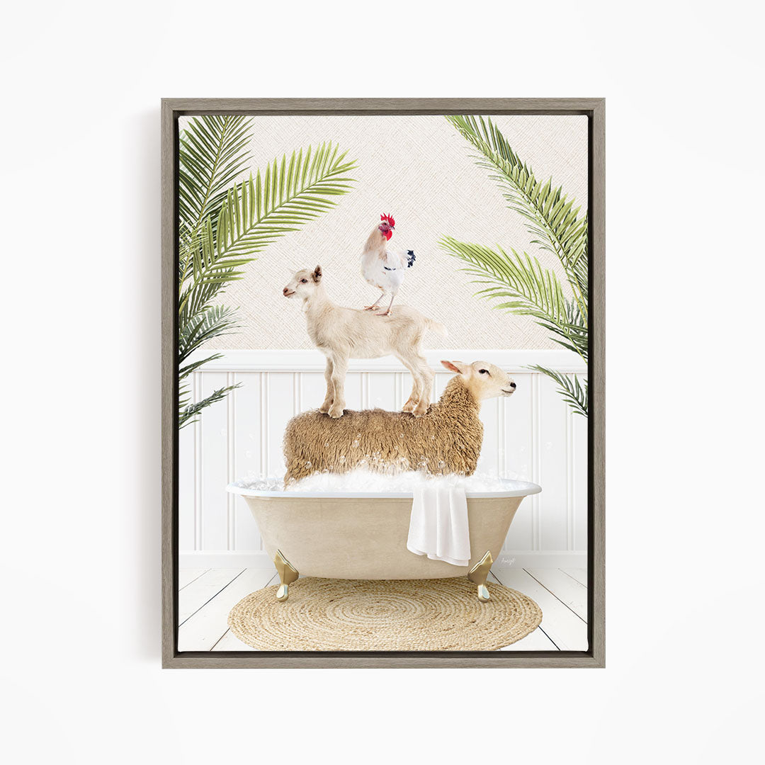 A framed image depicting a goat standing on a sheep's back while a chicken sits on top of the sheep, all in a bathtub surrounded by palm leaves.