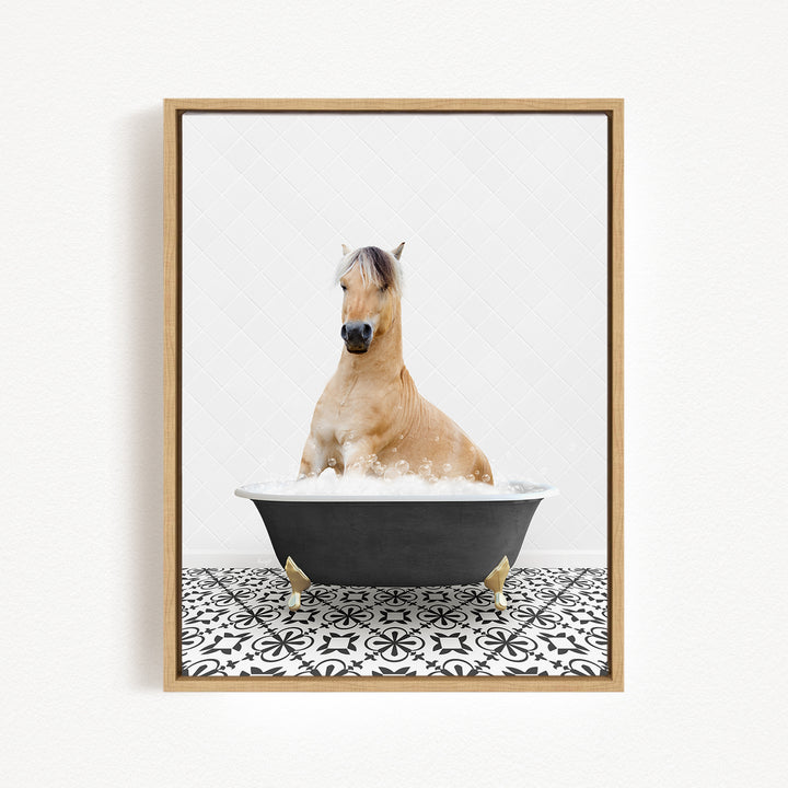 A light brown horse is sitting in a black bathtub filled with water, surrounded by a black and white patterned floor.