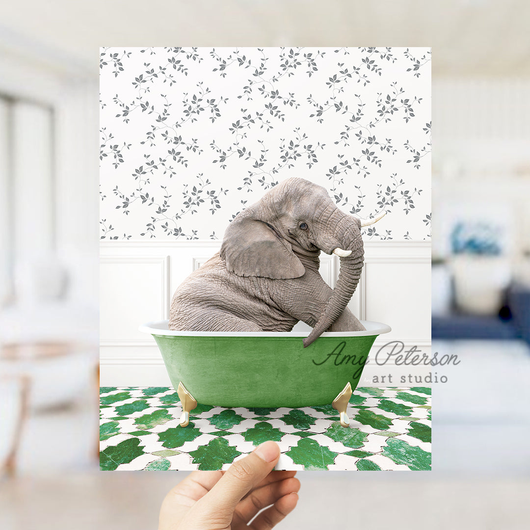 a person holding up a card with an elephant in a bathtub