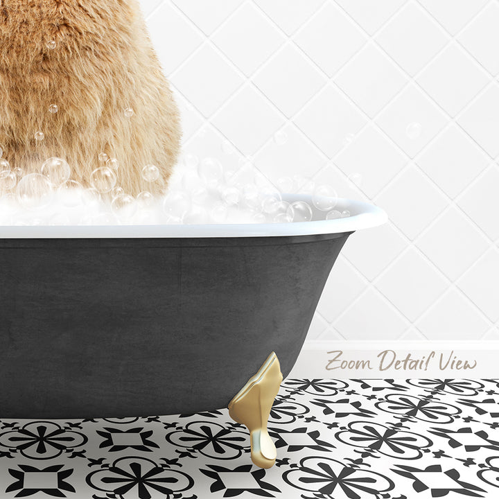 A cat is standing in a bathtub filled with bubbles, with a gold claw-like object on the floor.