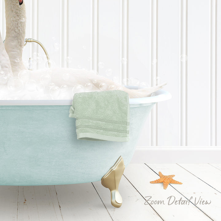 A white bathtub filled with bubbles, with a towel hanging on the side and a starfish on the floor.