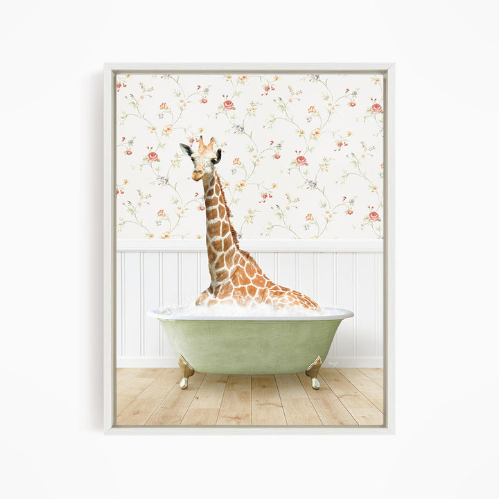 A giraffe is sitting in a green bathtub, surrounded by a floral wallpaper.