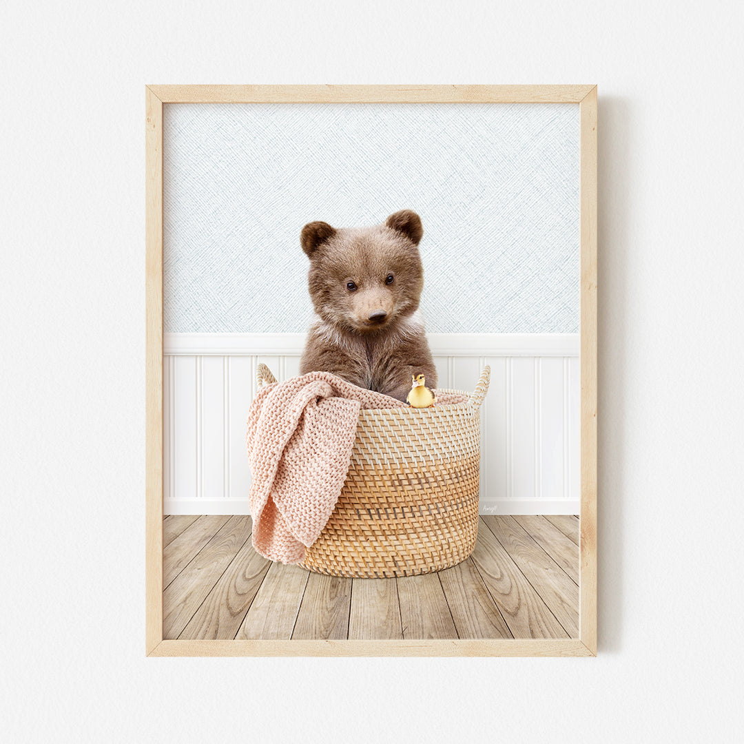 a brown teddy bear sitting in a basket