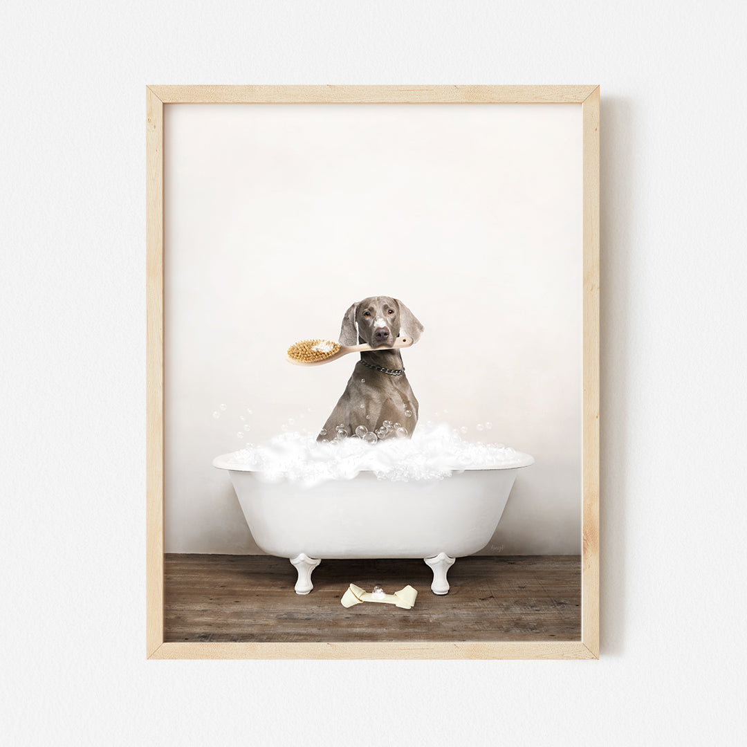 a dog sitting in a bathtub with a brush in its mouth