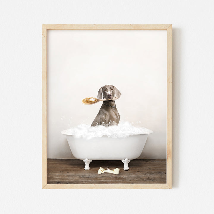 a dog sitting in a bathtub with a brush in its mouth