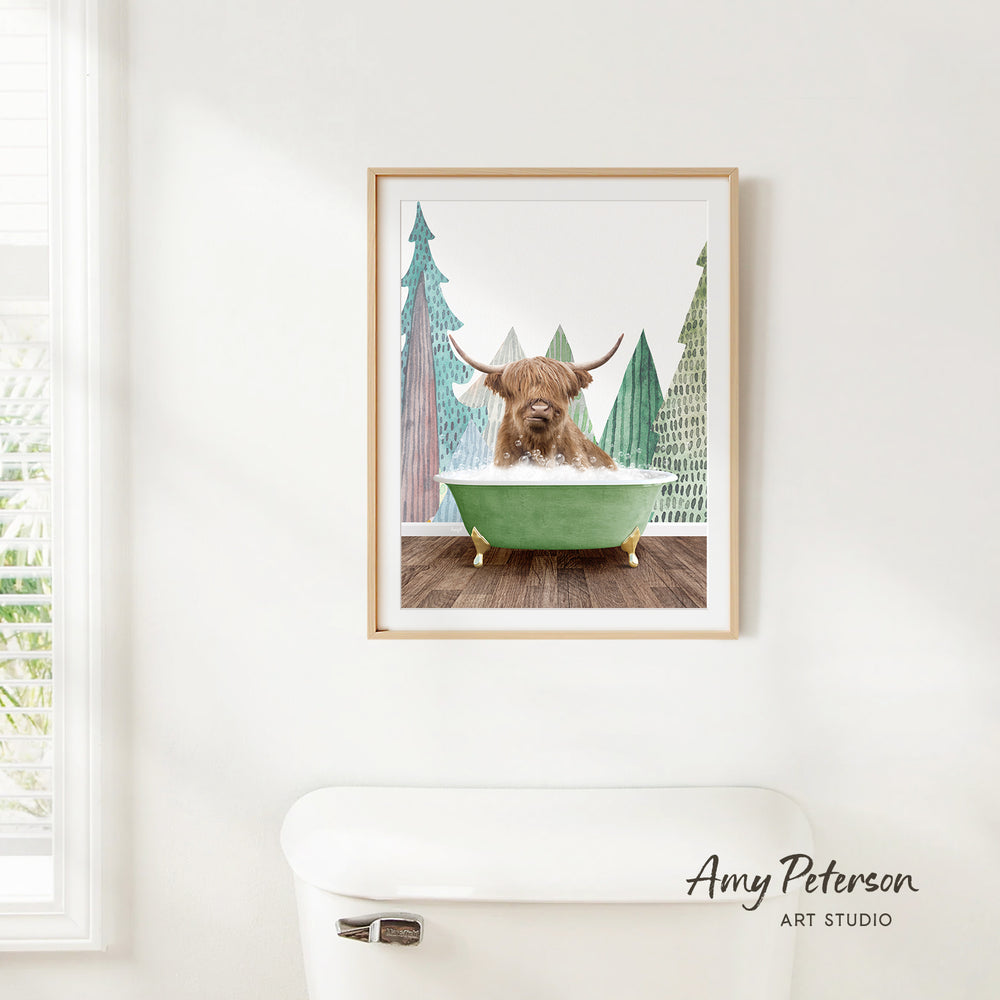 A framed print of a brown cow sitting in a green bathtub, surrounded by trees, is hanging on a white wall.