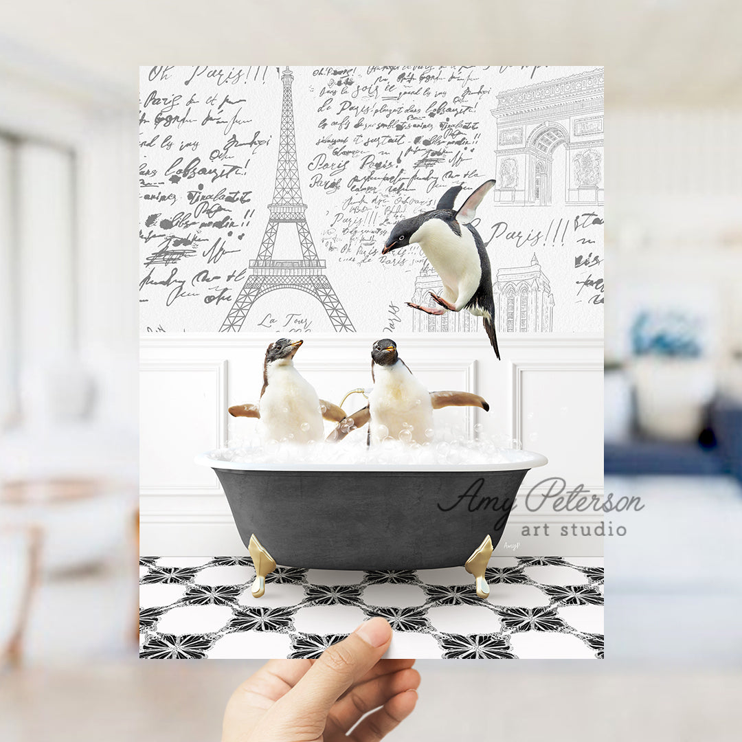 a person holding up a card with penguins in a bathtub