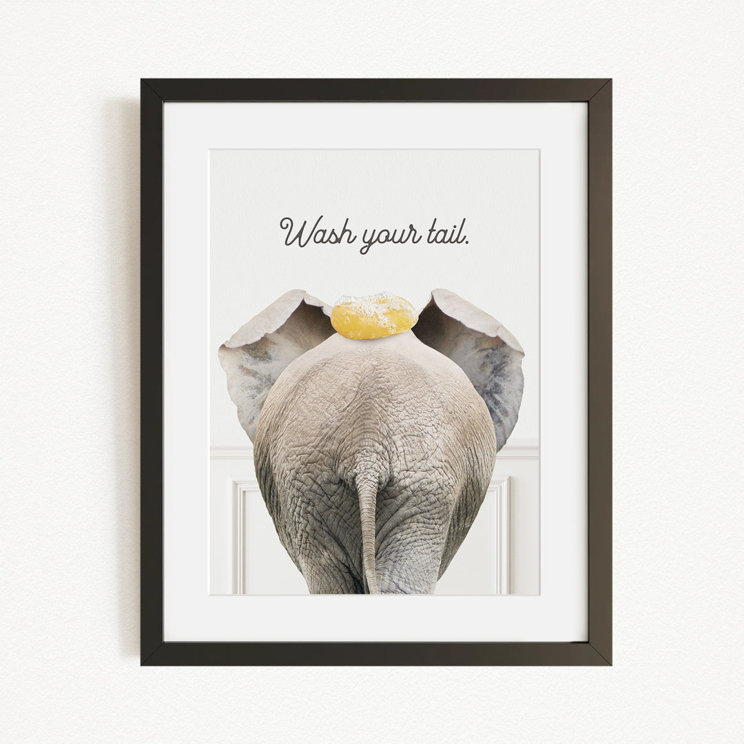 an elephant with a yellow object on its head, accompanied by the text "Wash your tail."