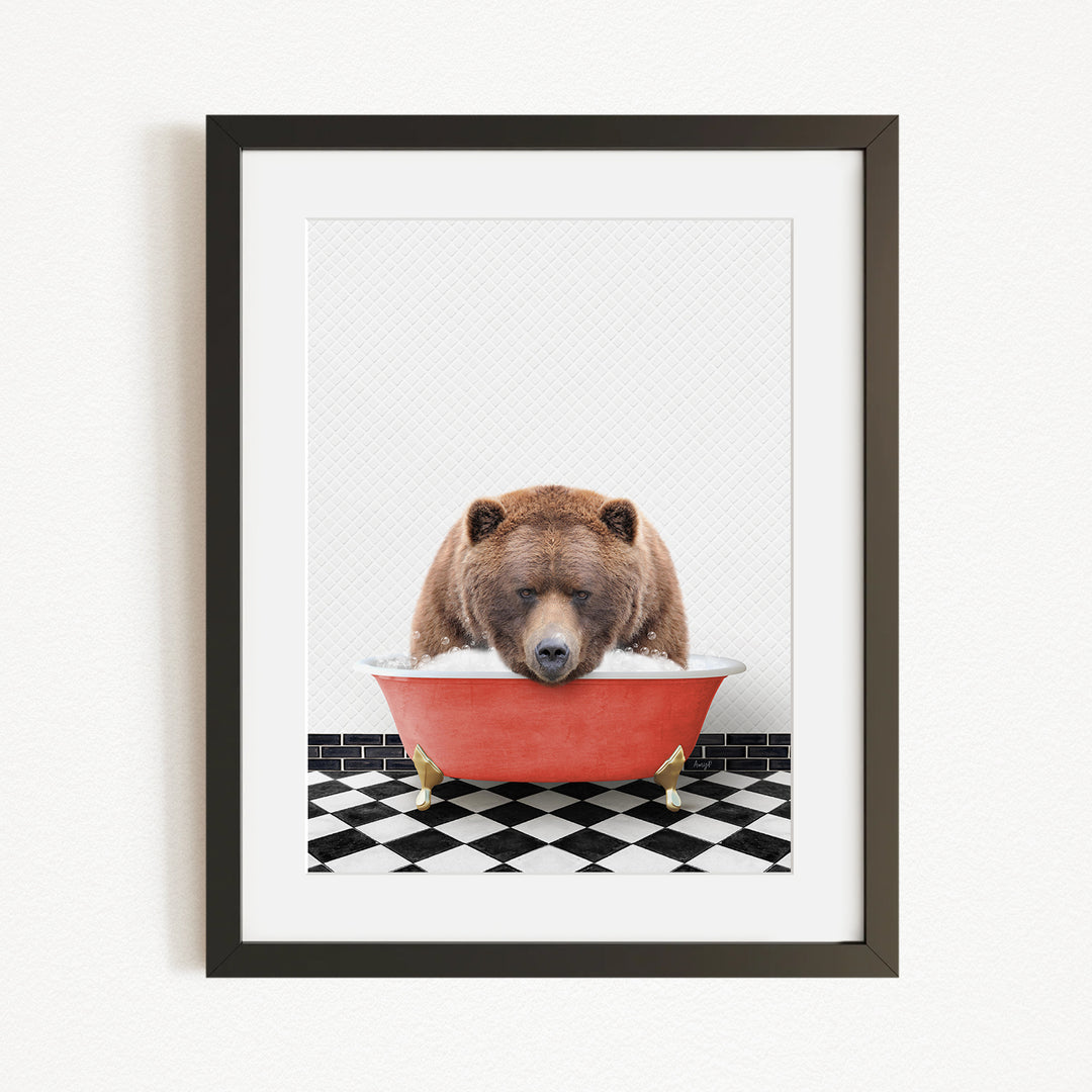 A brown bear is sitting in a red bathtub filled with water, appearing to enjoy a relaxing bath.