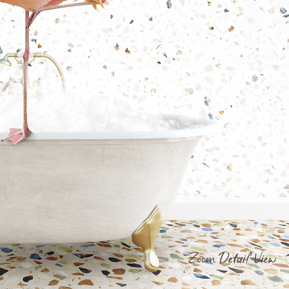 A white clawfoot bathtub filled with water, with a colorful mosaic floor in the foreground.