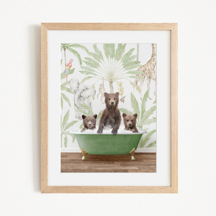 A framed print depicting three bears sitting in a green bathtub, surrounded by a tropical jungle wallpaper.
