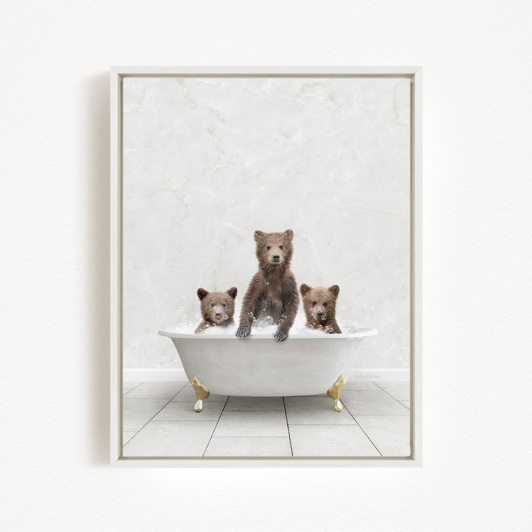 Three adorable brown bears sitting in a white bathtub, enjoying a relaxing bath together.