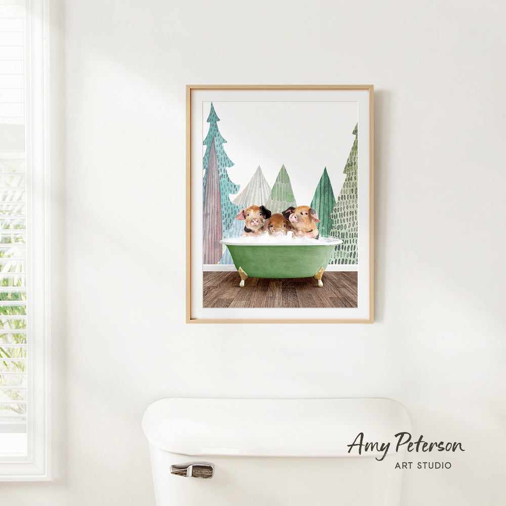 A framed print of two hamsters sitting in a green bathtub, surrounded by a forest scene with pine trees and a snowy landscape.