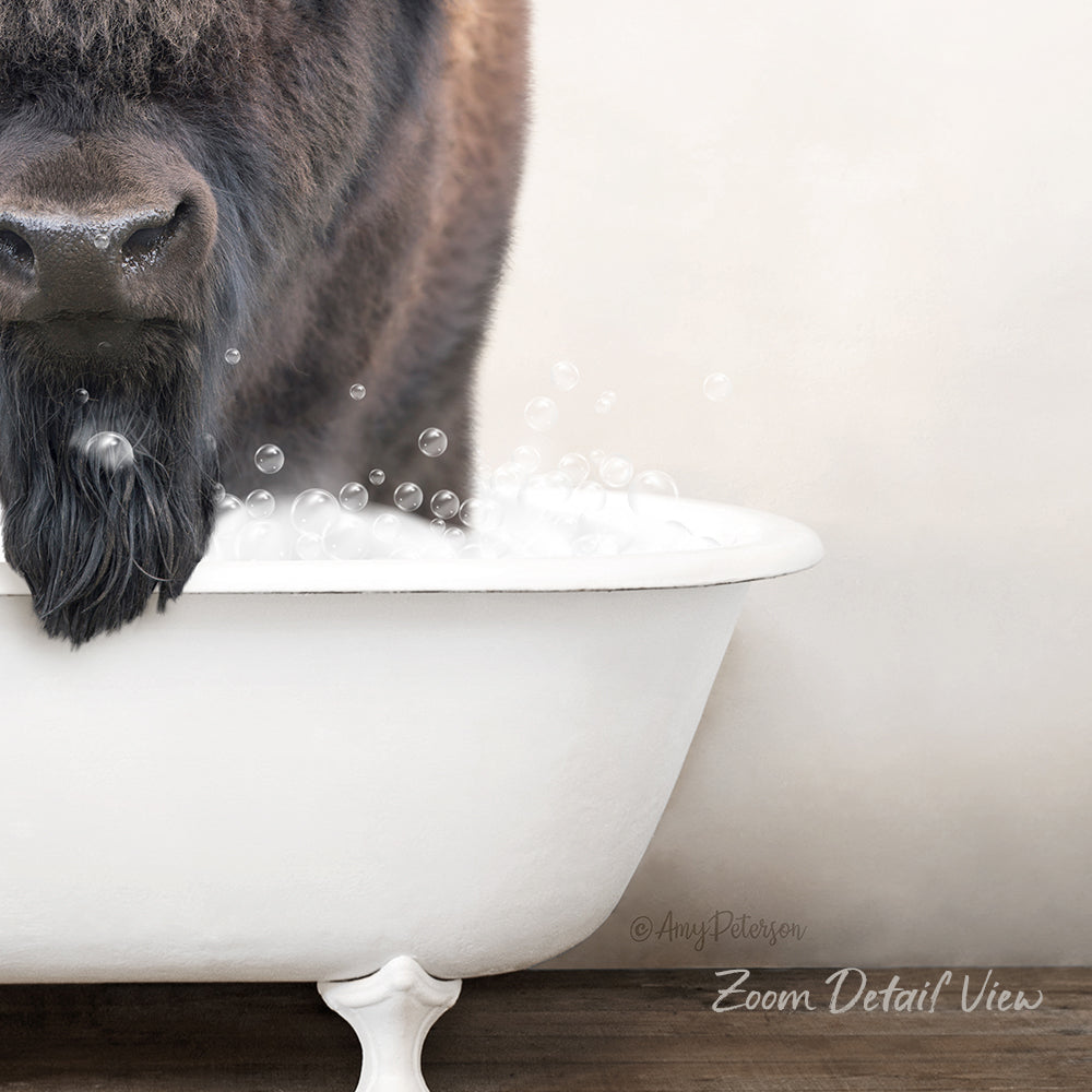 A close-up of a bison's head in a white bathtub filled with bubbles, creating a whimsical and playful scene.