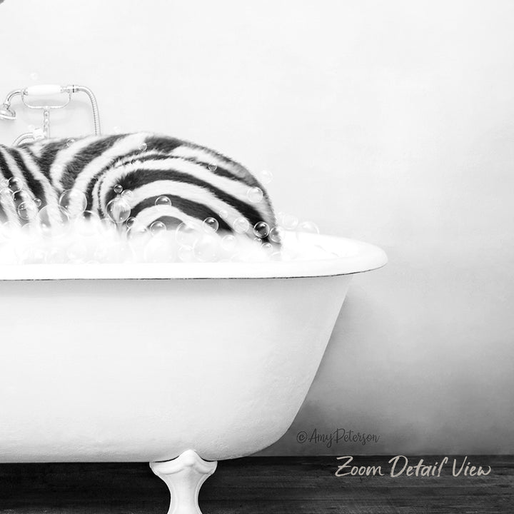 A zebra lying in a white bathtub filled with bubbles, creating a whimsical and playful scene.