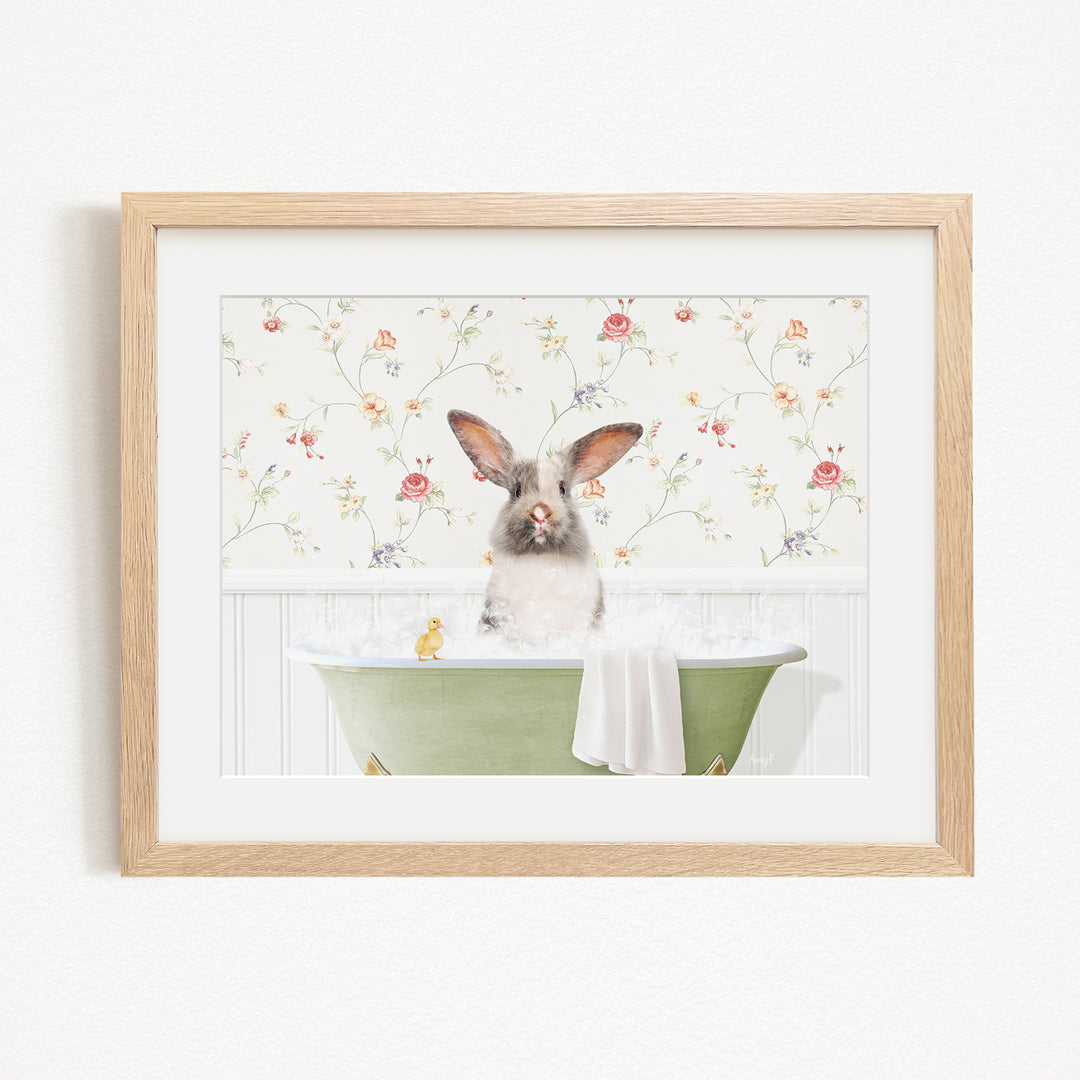 A fluffy white rabbit sits in a green bathtub filled with water, surrounded by a floral wallpaper.