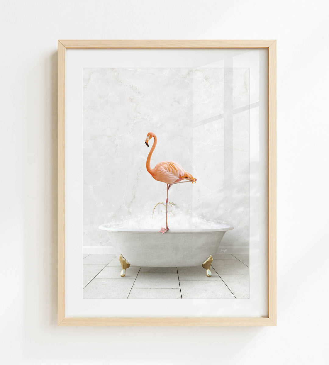 A framed image of a pink flamingo standing on a white bathtub, with bubbles surrounding it.