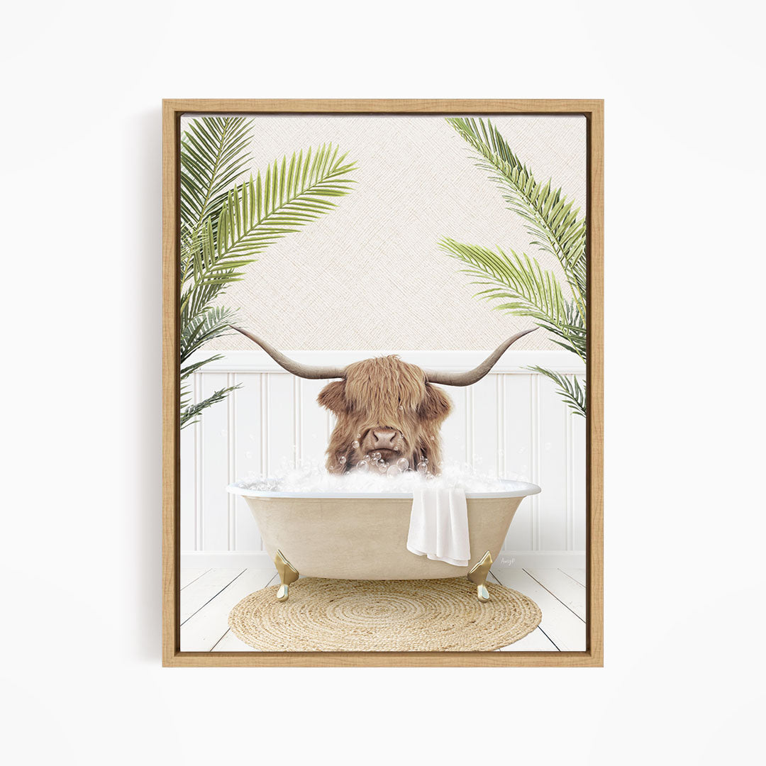 A brown cow with long horns is sitting in a bathtub filled with water, surrounded by green palm leaves.
