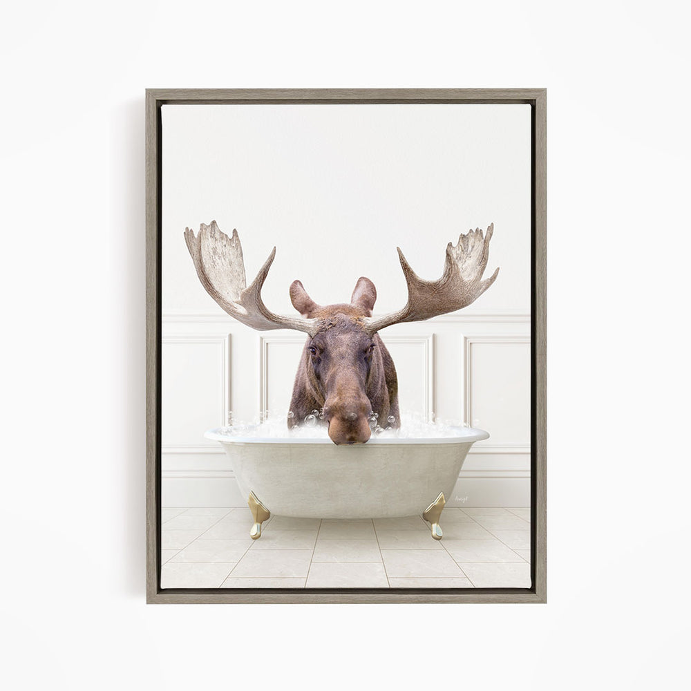 A moose with large antlers is sitting in a bathtub filled with water, creating a whimsical and humorous scene.