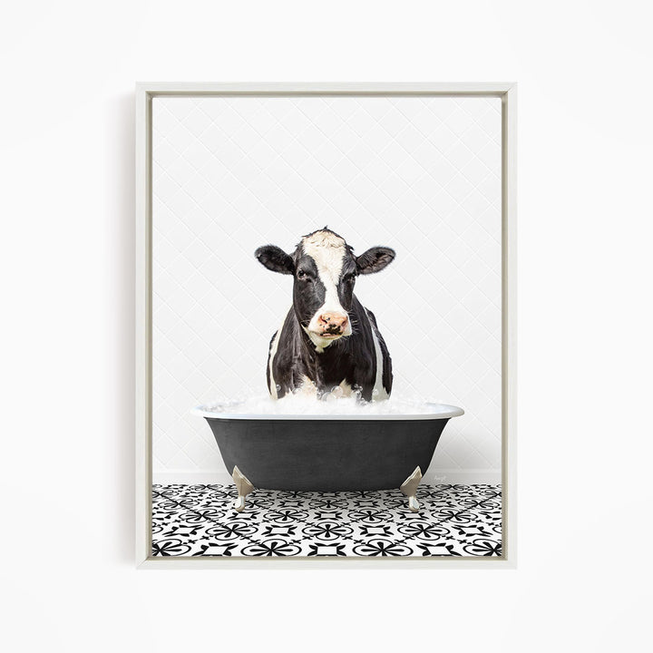 A black and white cow is standing in a bathtub filled with water, creating a whimsical and humorous scene.