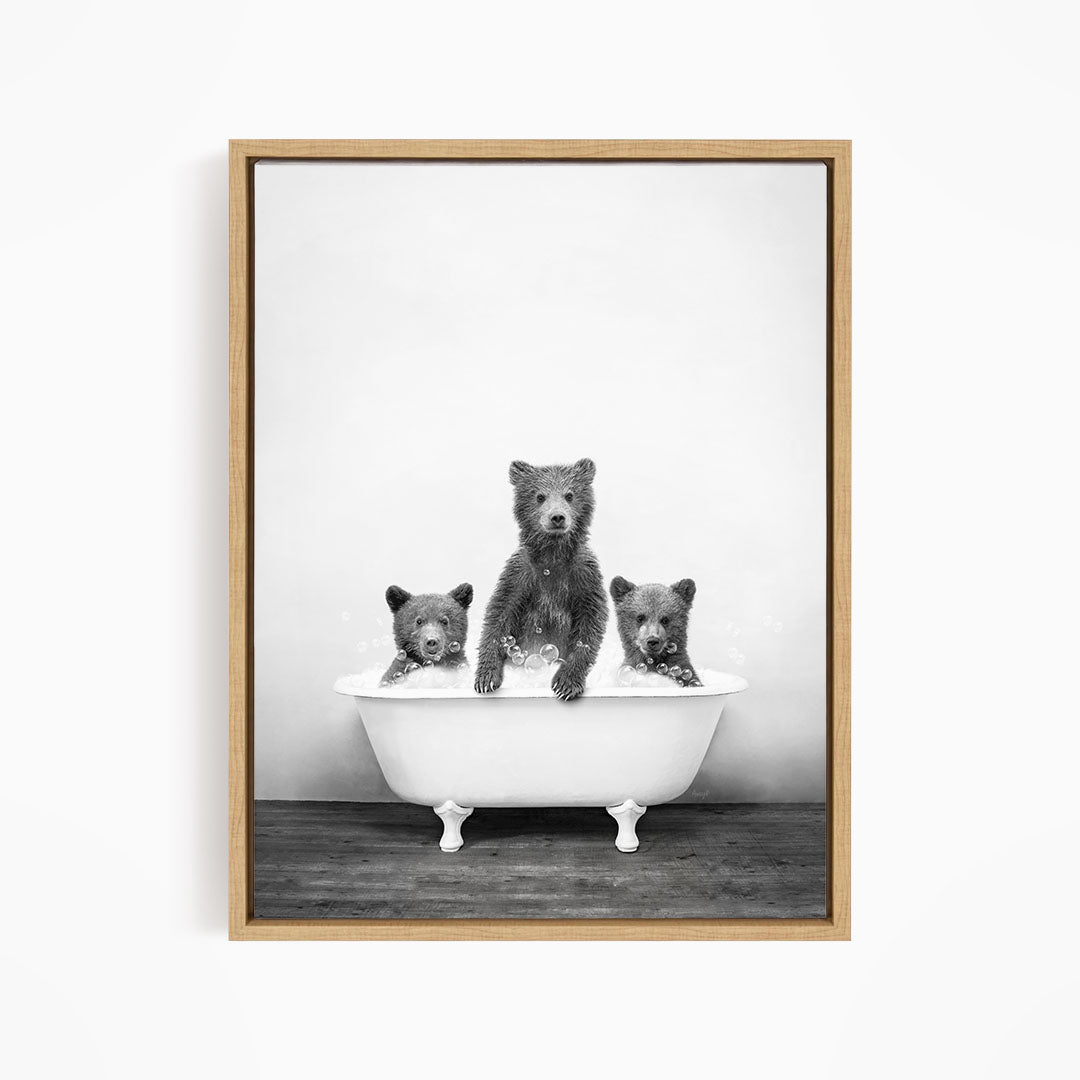 A black and white image of three bears sitting in a bathtub, with one bear sitting in the center and the other two bears sitting on either side.