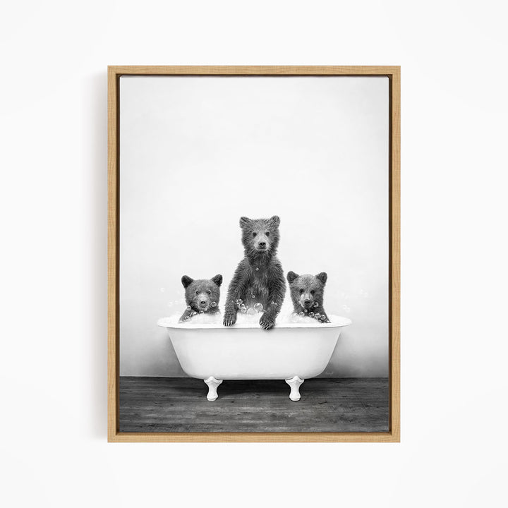 A black and white image of three bears sitting in a bathtub, with one bear sitting in the center and the other two bears sitting on either side.