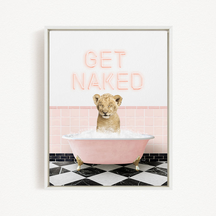 A young lion cub sitting in a pink bathtub, with the text "GET NAKED" displayed above it.