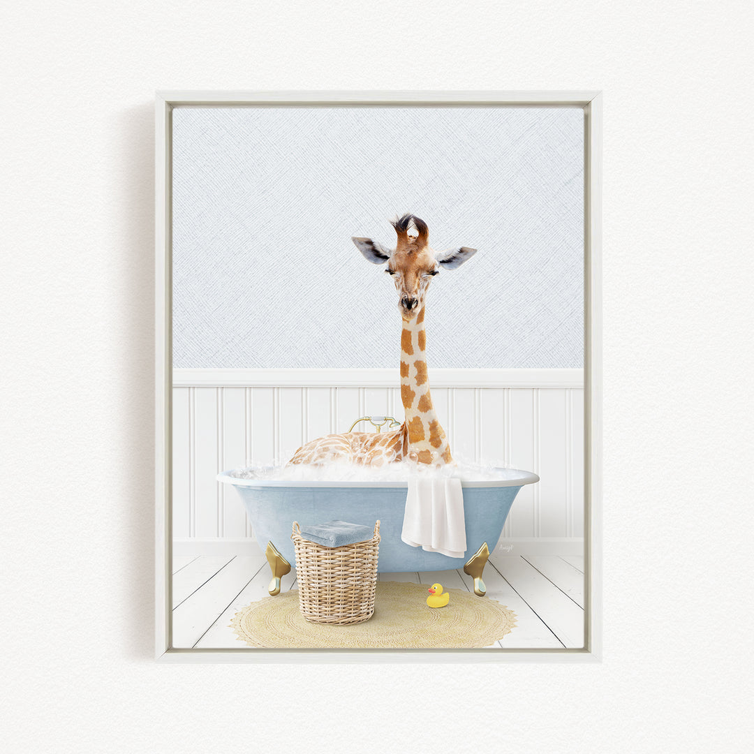 A giraffe is sitting in a blue bathtub filled with water, surrounded by a basket of toys and a yellow rubber duck.
