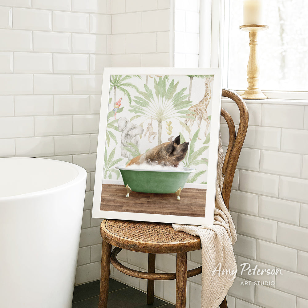 A framed painting of a dog sitting in a bathtub, surrounded by tropical foliage, is displayed on a wooden chair in a bathroom setting.