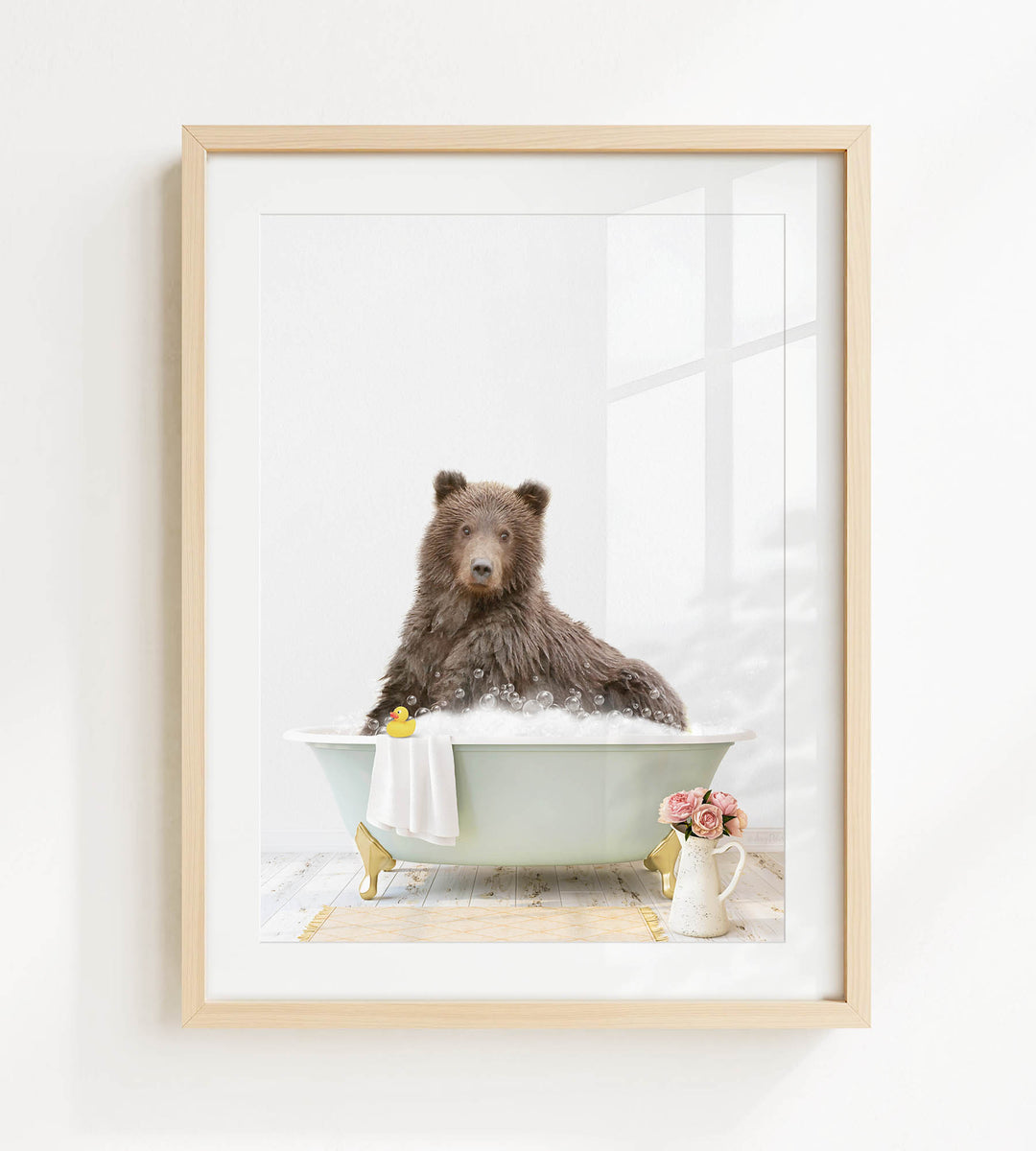 A brown bear sitting in a bathtub filled with bubbles, surrounded by a yellow rubber duck, a white vase with pink flowers, and a white towel.