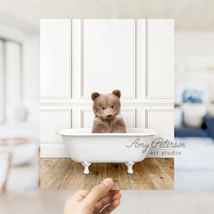 a small teddy bear sitting in a bath tub