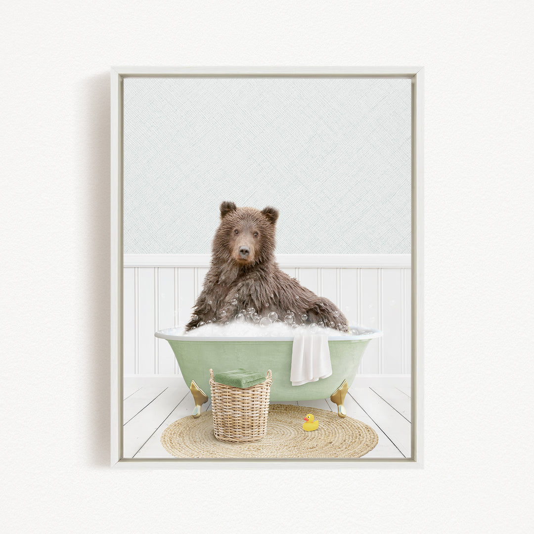 A brown bear sitting in a green bathtub filled with bubbles, surrounded by a basket of toys and a yellow rubber duck.