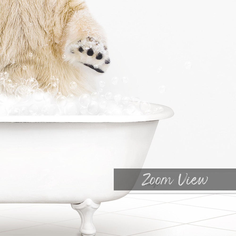 A polar bear's paw is submerged in a white bathtub filled with bubbles, creating a playful and whimsical scene.