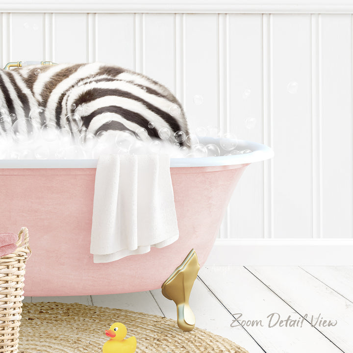 A zebra lying in a pink bathtub filled with bubbles, surrounded by a yellow rubber duck and a white towel.
