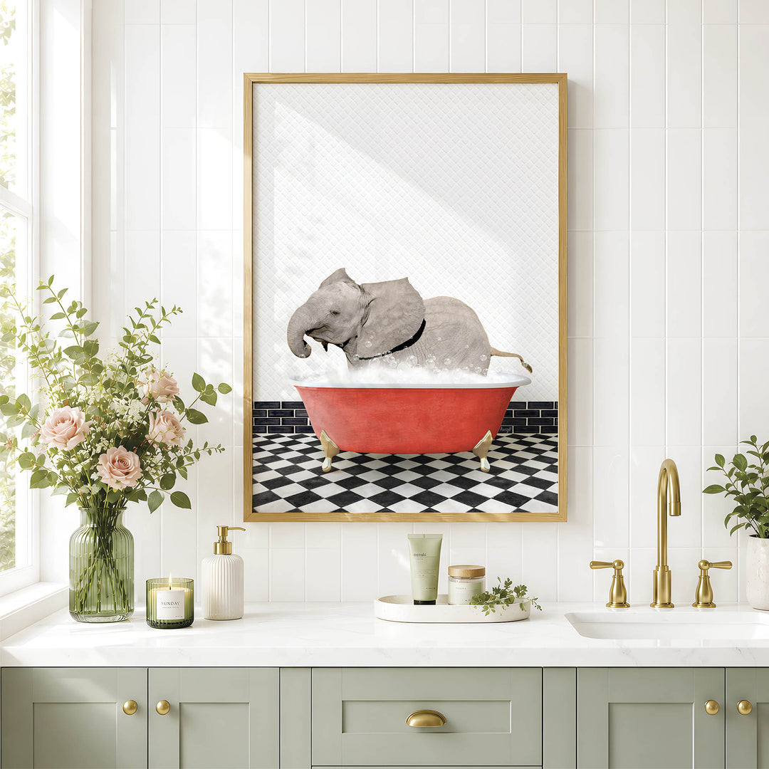 a bathroom scene with a framed picture of an elephant sitting in a red bathtub, surrounded by flowers and greenery.