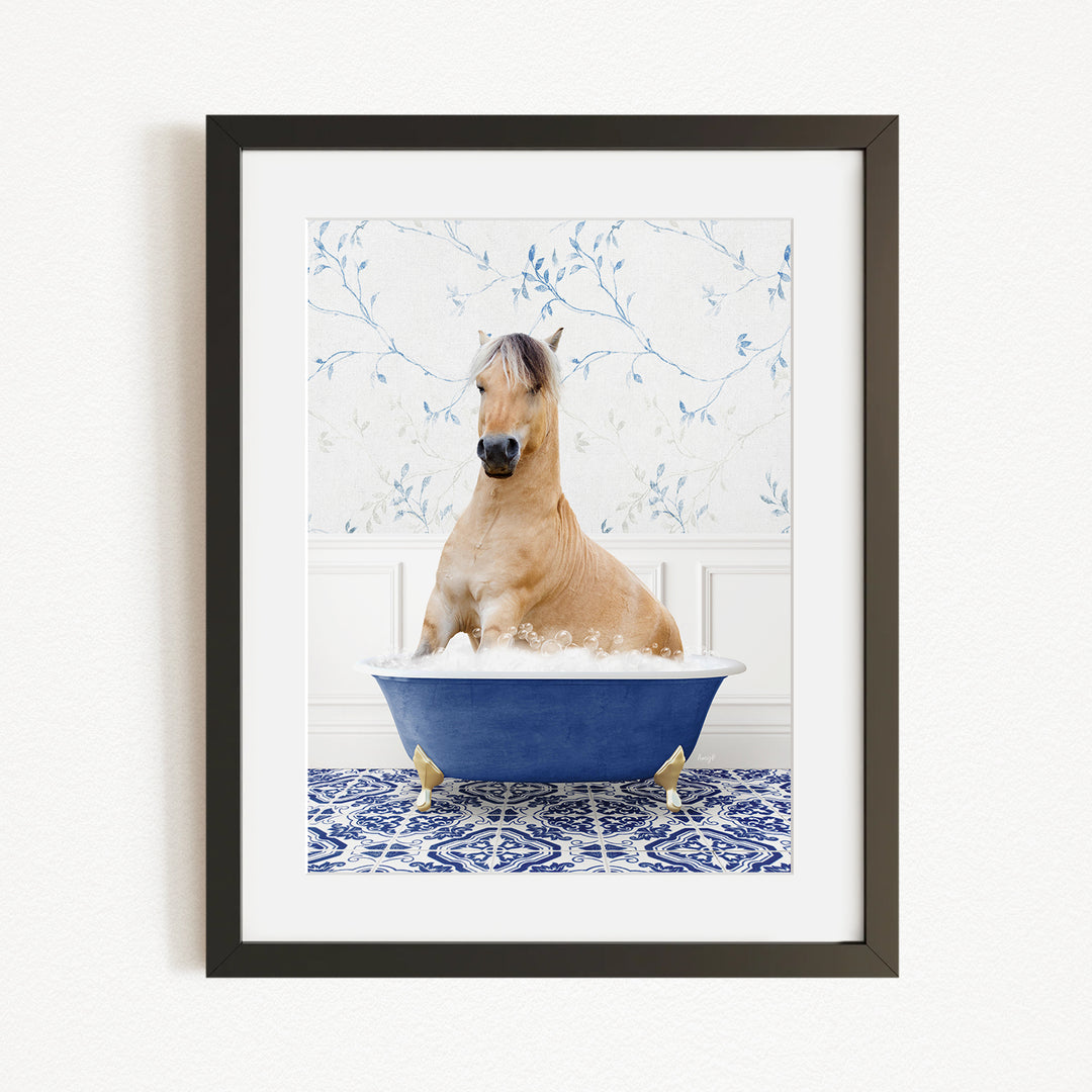 A light brown horse is sitting in a blue bathtub filled with water, surrounded by a blue and white patterned floor.