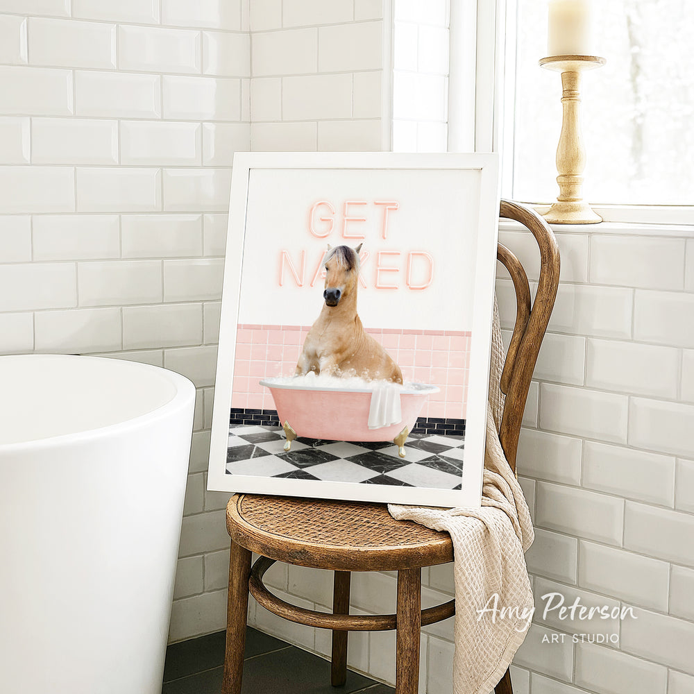 A framed image of a dog sitting in a pink bathtub, with the text "GET NAKED" displayed on the frame.