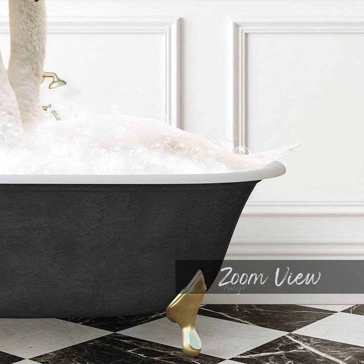 A black bathtub filled with bubbles, with a gold bathtub faucet and footrest, and a gold-colored swan standing on the edge of the tub.