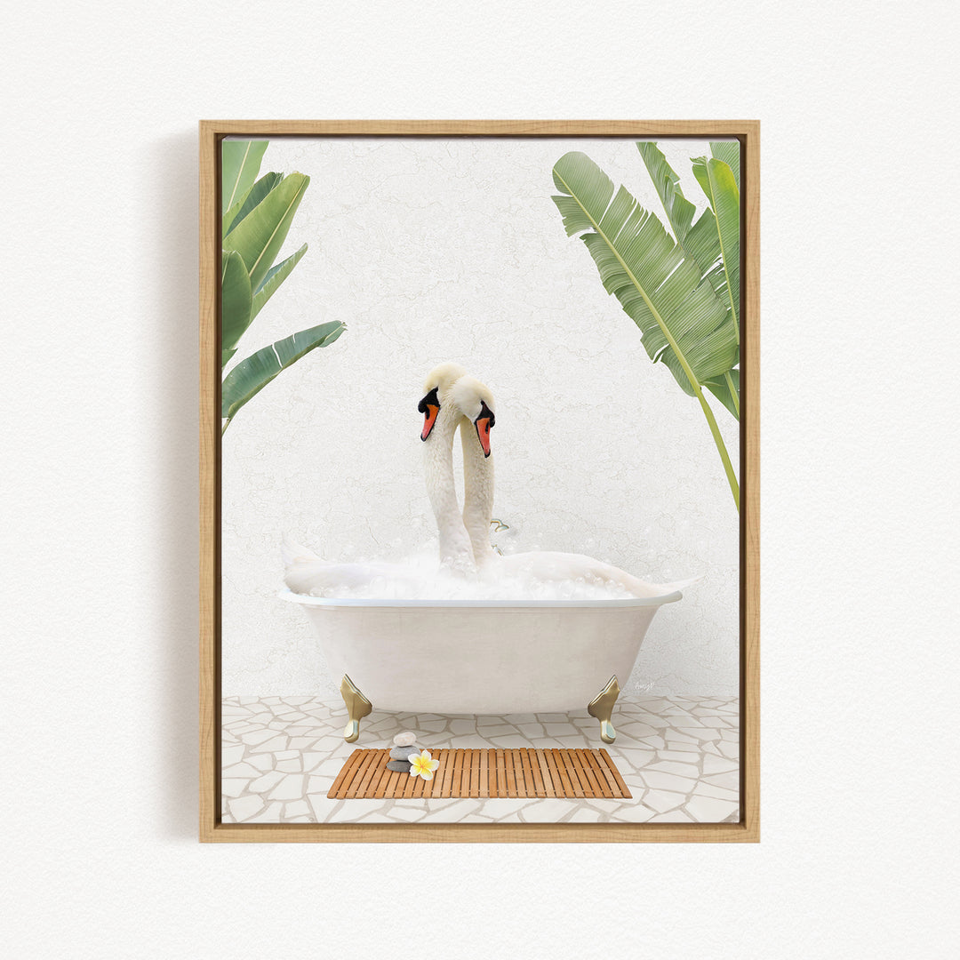 A pair of swans bathing in a white bathtub, surrounded by green leaves, with a wooden mat on the floor in front of the tub.