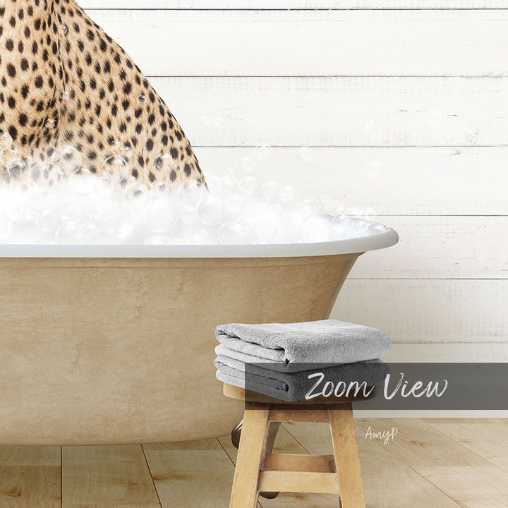 A leopard print towel is placed on a wooden stool next to a bathtub filled with bubbles, creating a relaxing and spa-like atmosphere.