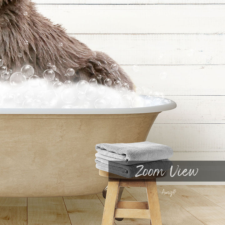 A brown dog is sitting in a bathtub filled with bubbles, with a towel and stool nearby.