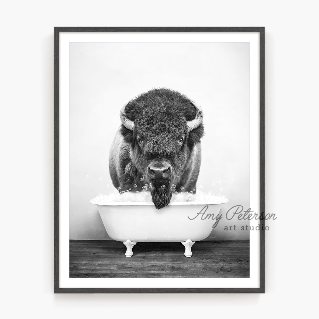 a black and white photo of a bison in a bathtub