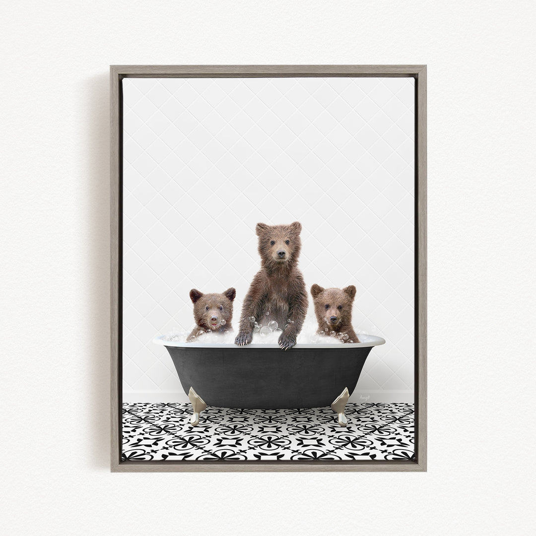 Three adorable brown bears sitting in a black bathtub, with one bear in the center and the other two on either side.