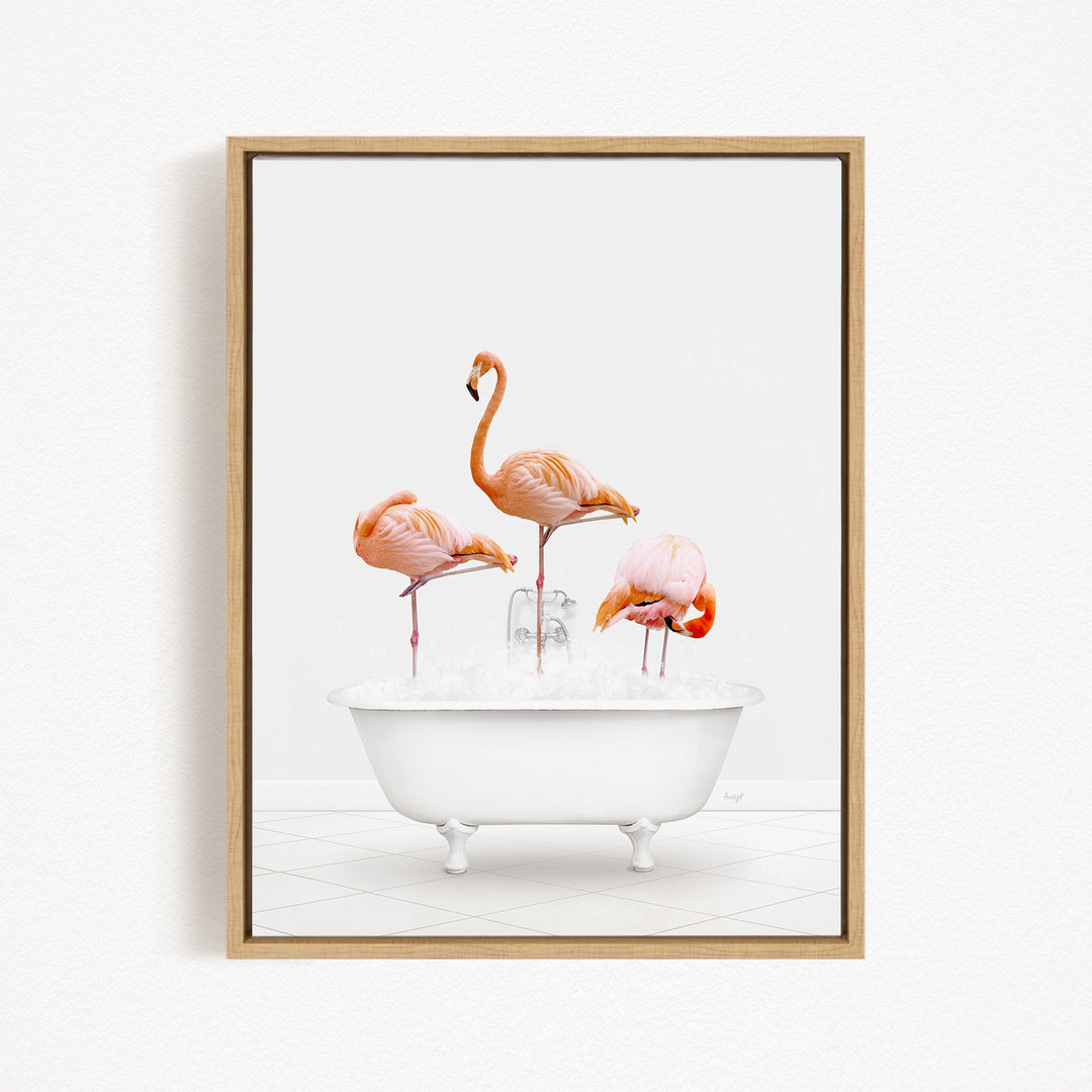 A framed image depicting three flamingos standing in a white bathtub filled with water.